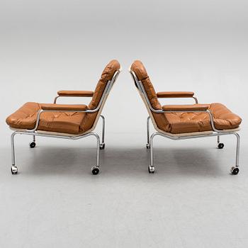 A pair of leather upholstered easy chairs, 1960's/70's.