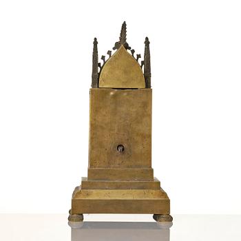 An English neo-Gothic patinated and ormolu mechanical mantel clock, ca 1820.