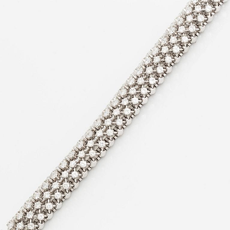 A platinum bracelet set with round brilliant-cut diamonds.