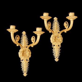 1237. A pair of Empire early 19th century gilt bronze two-light wall-lights.