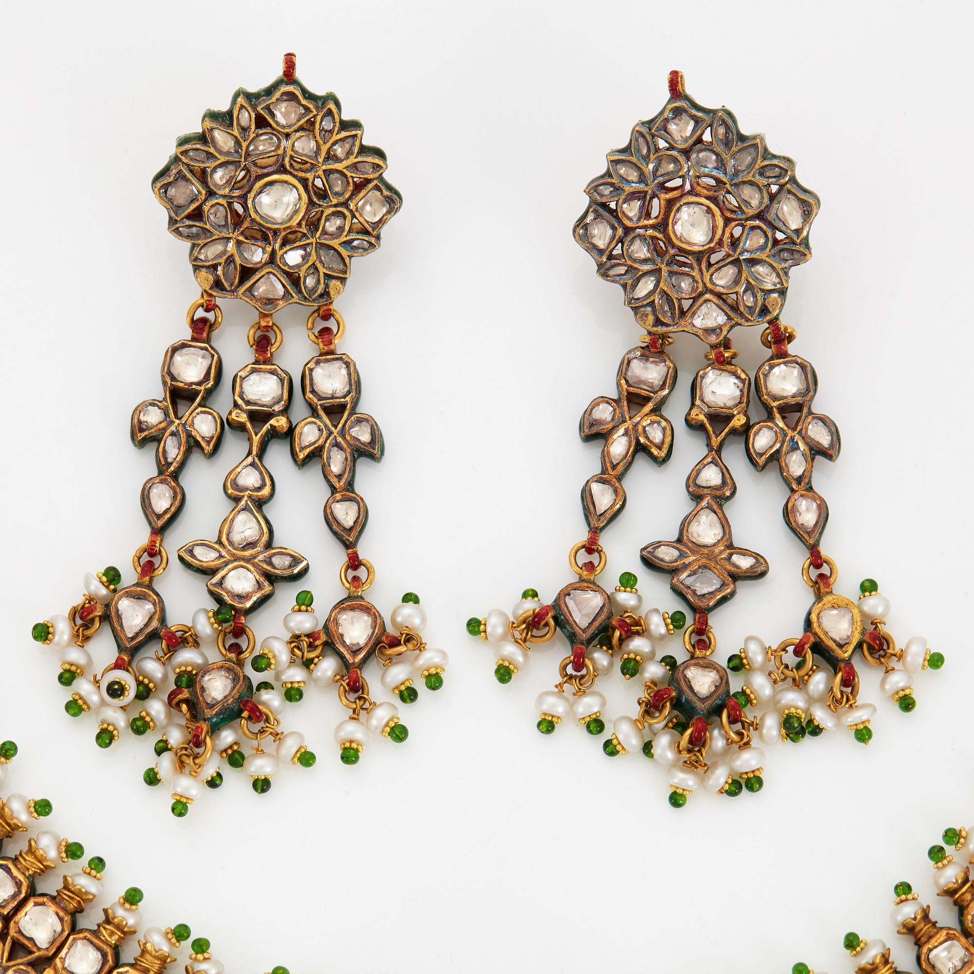 An Indian demi parure comprising a necklace and a pair of earrings.