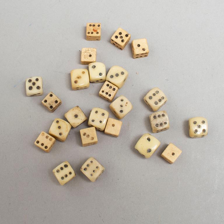 A set of 24 19th century miniature bone and stone dice.