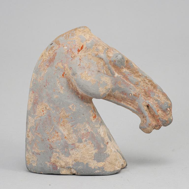 A pottery model of a horses head, Han dynasty (206 BC-220 AD).