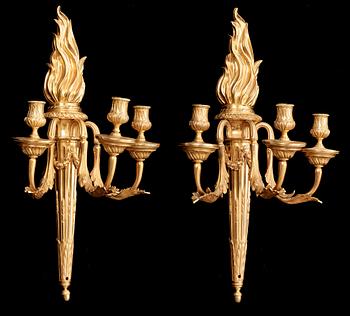 A pair of Louis XVI late 18th century gilt bronze three-light wall-lights.