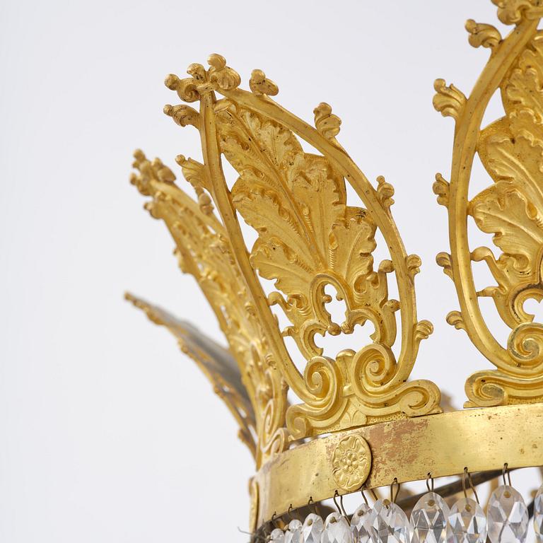 An French Empire eight-light gilt-brass and cut-glass chandelier.