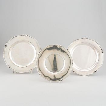 Three silver serving plates, decorated with "knots", Swedish import marks.