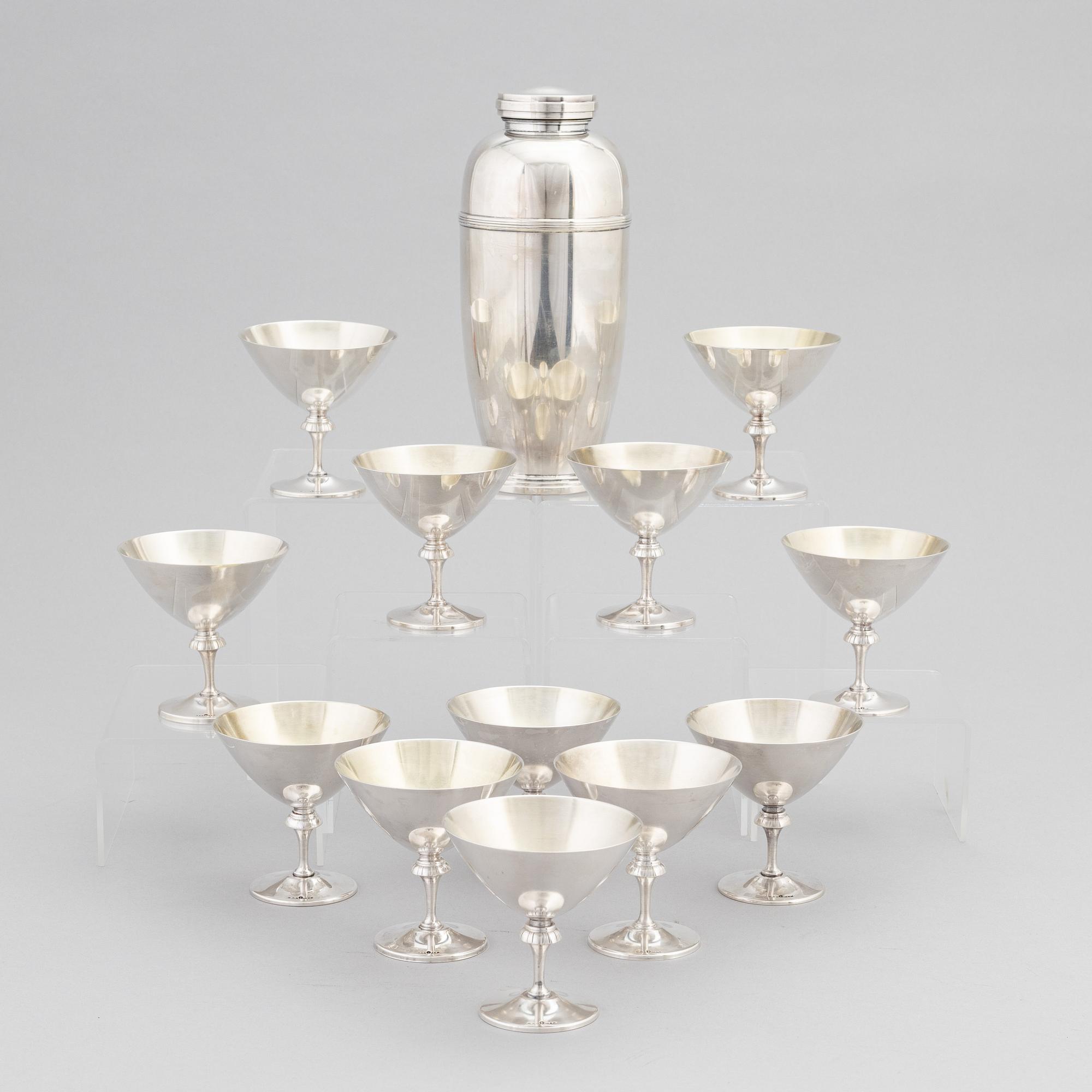 A silver plated shaker, C.G. Hallberg and a set of twelwe cocktail glasses, GAB, second half of the 20th Century.