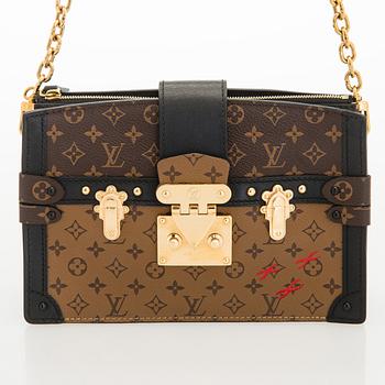 Louis Vuitton, a "Reverse Monogram Trunk Clutch" bag.