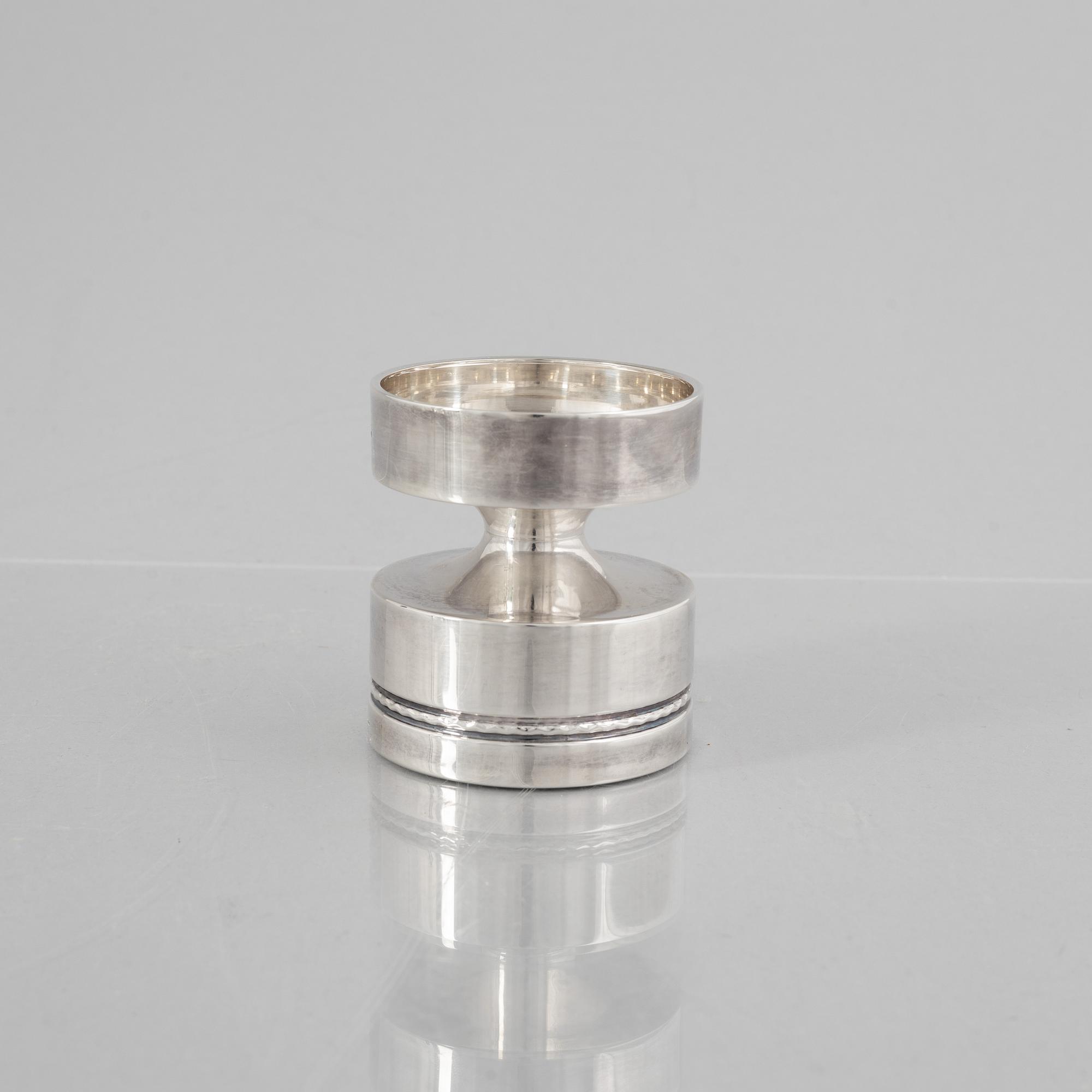 Eric Löfman, a Swedish silver candlestick, a vase and four cups, including MGAB, Uppsala 1977.