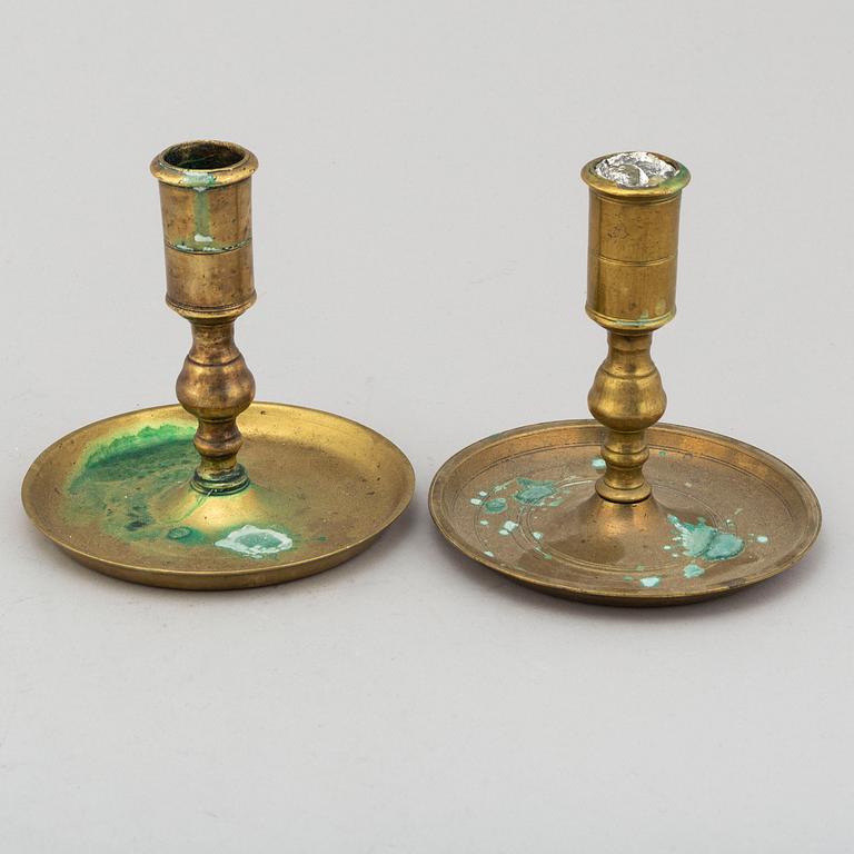 TWO CANDLESTICKS, brass, ca 1800.