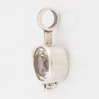 A silver and rock crystal pendant.