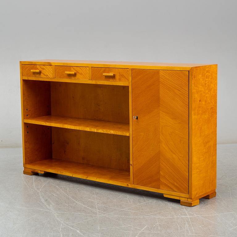 A 1930s birch and elm veneered shelf.