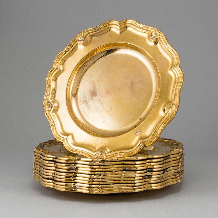 A German set of twelve 19th century silver-gilt plates, mark of Hossauer, Berlin. Rokoko-style.