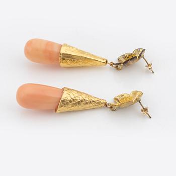 A pair of brass tone metal and stone earrings, Firma Svenskt Tenn.