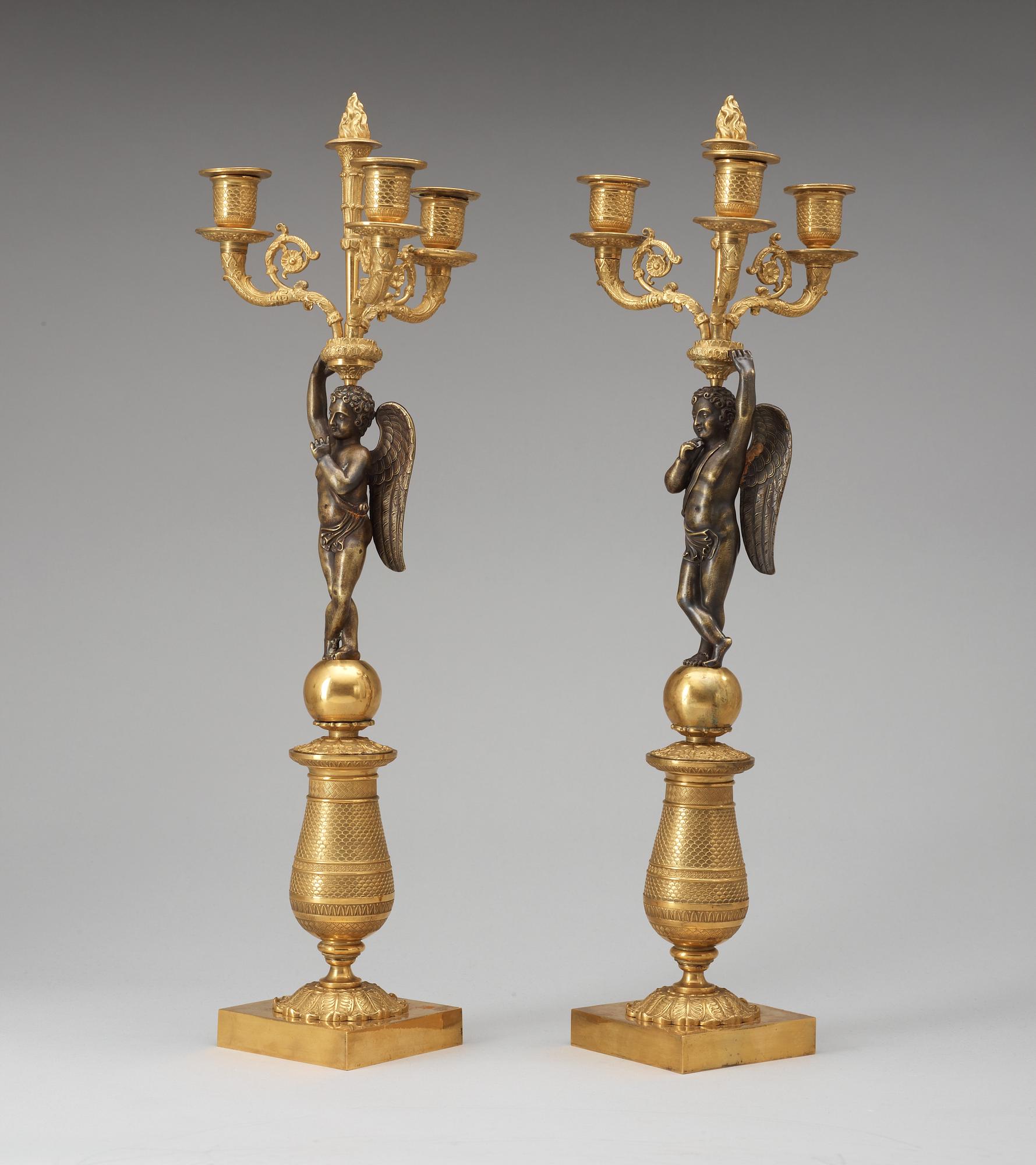 A pair of French Empire early 19th century three-light candelabra.