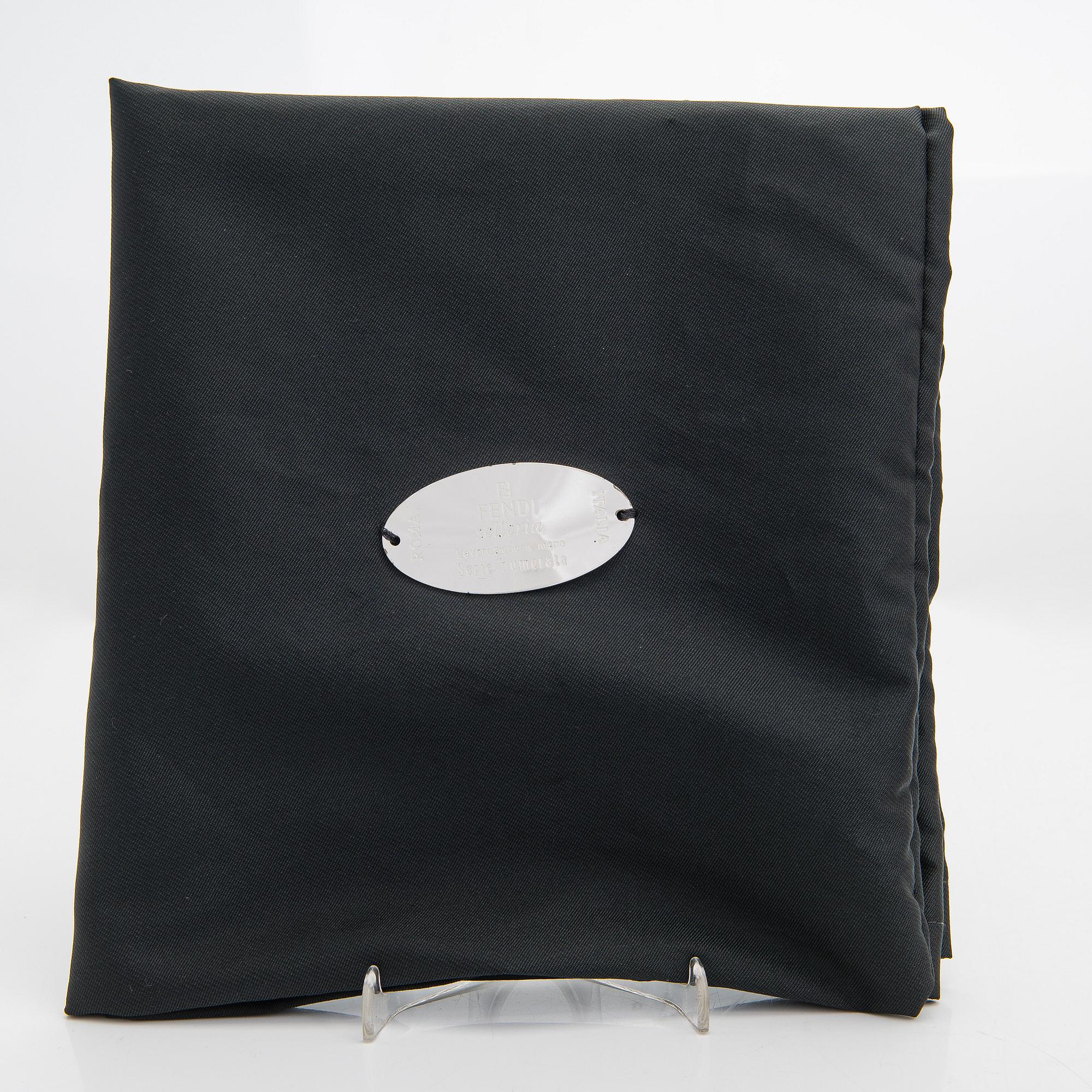 Fendi, a brown leather bag.