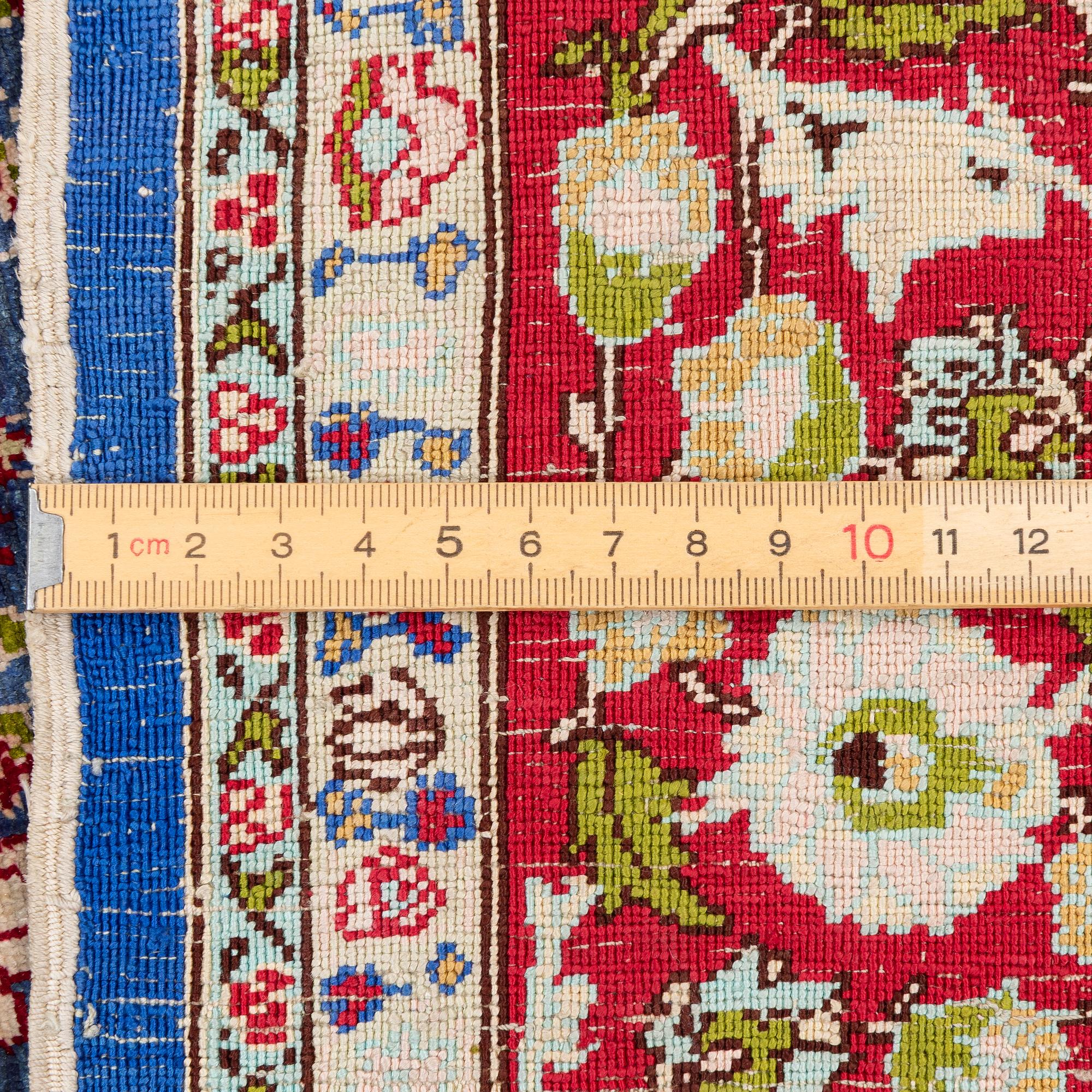 An Oriental silk rug, signed, c. 125 x 85 cm.