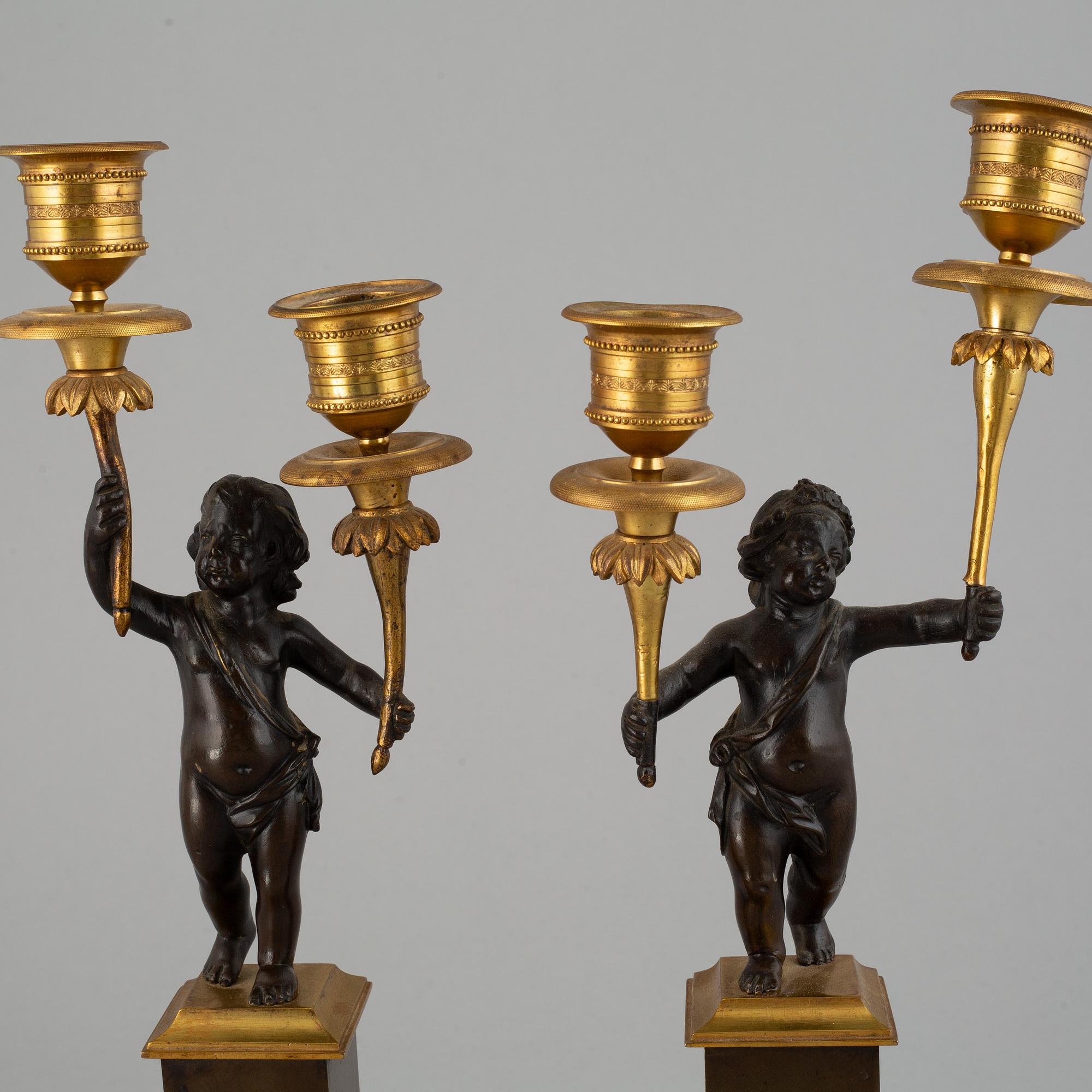 A pair of bronze empire style candleabra, 20th century.