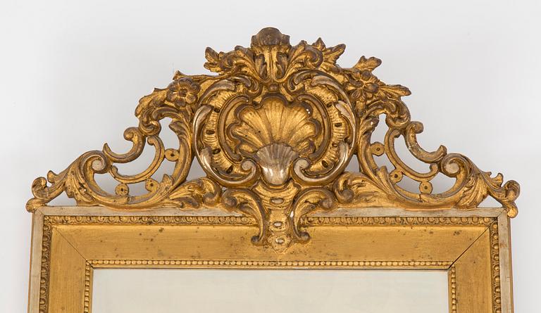 A Swedish Gustavian style mirror and console table with marble top from the first half of the 20th century.