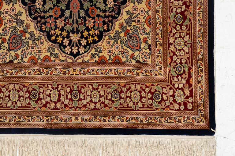 A Hereke silk rug, c. 130 x 71 cm.