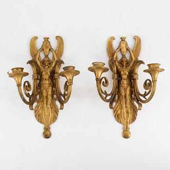 A pair of bronze two light wall-lights, early 20th century.