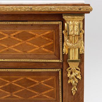 A Louis XVI-style chest of drawers, circa 1900.