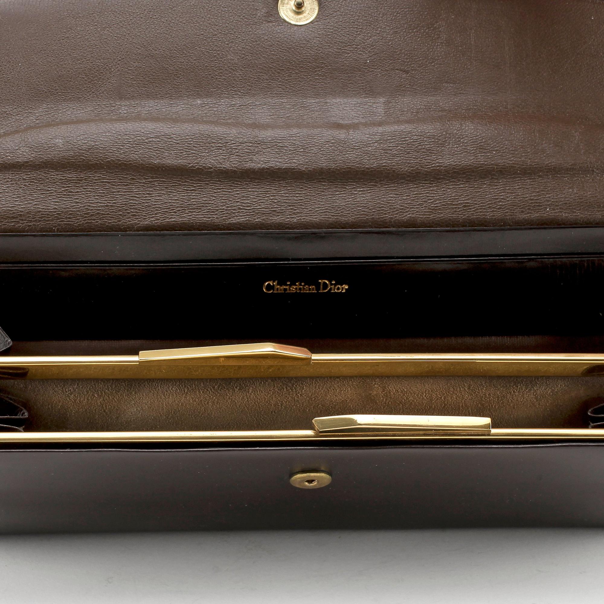 CHRISTIAN DIOR, a brown calf leather clutch / evening bag.