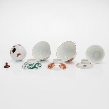 A set of seven bowls of which three with lids and a small famille rose jar, including Guangxu mark, China, circa 1900.