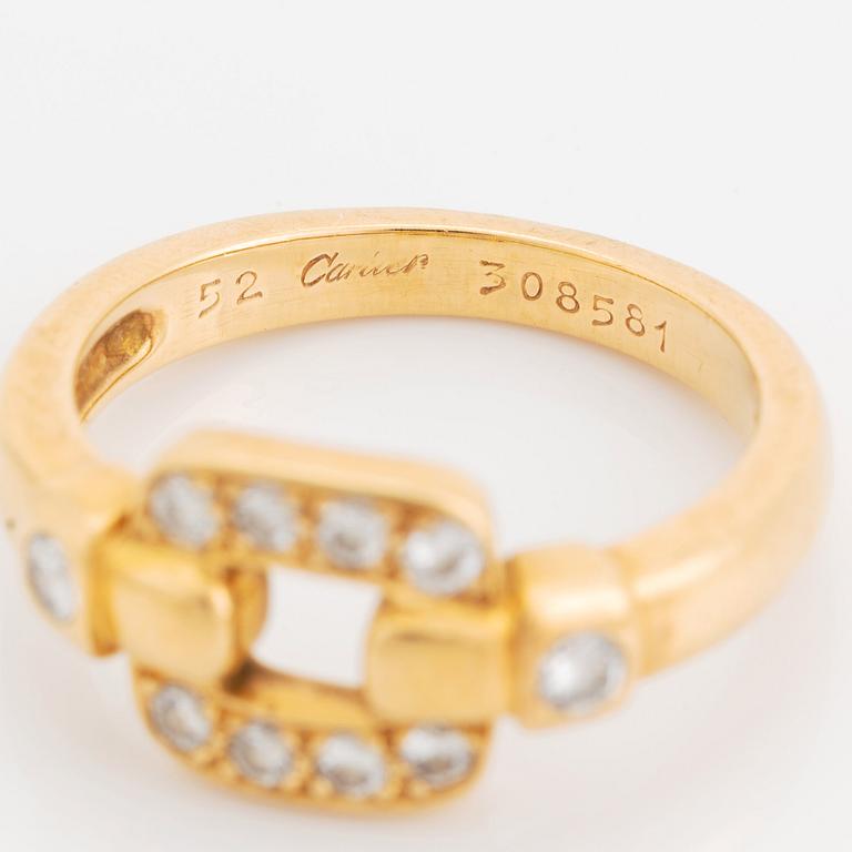 An 18K gold Cartier ring set with round brilliant-cut diamonds.