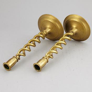 A pair of brass candle sticks. possibly English, circa 1900.