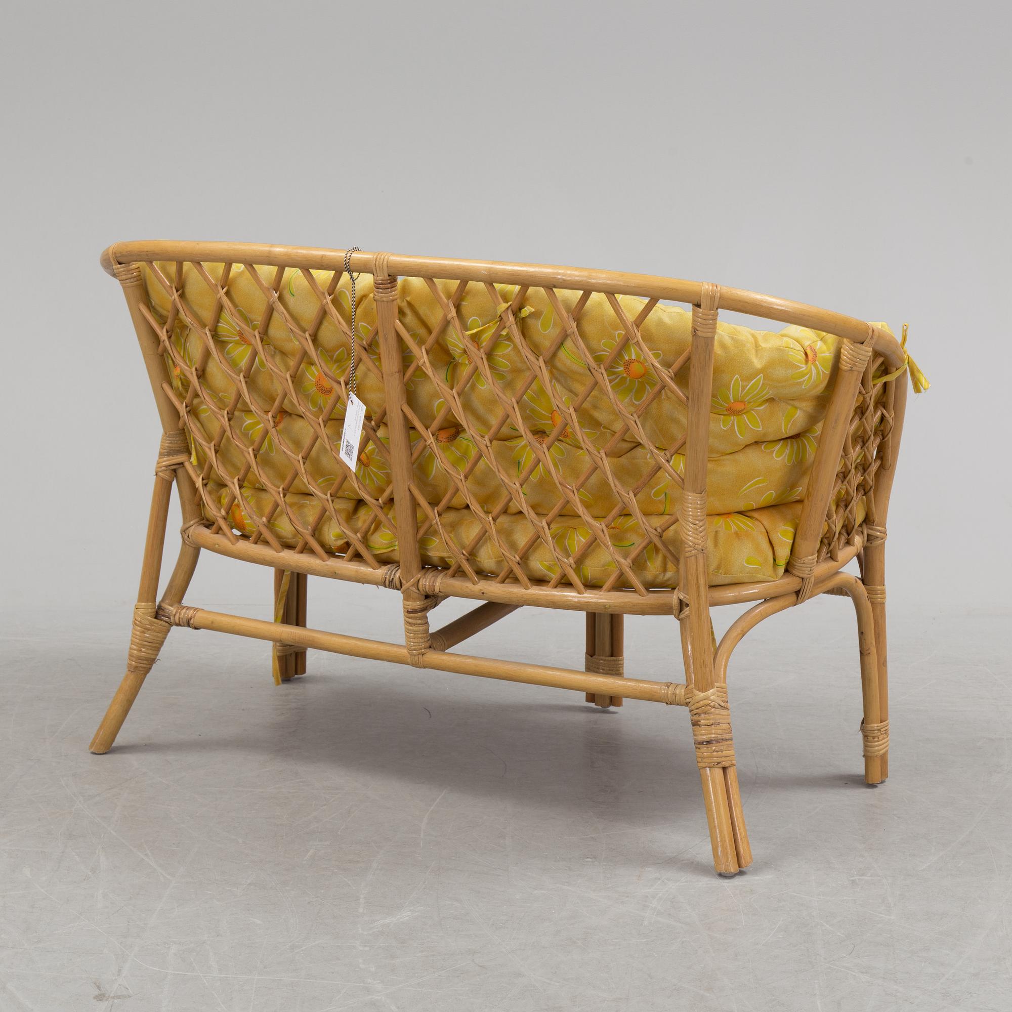 A 1970s four piece set of rattan garden furniture.
