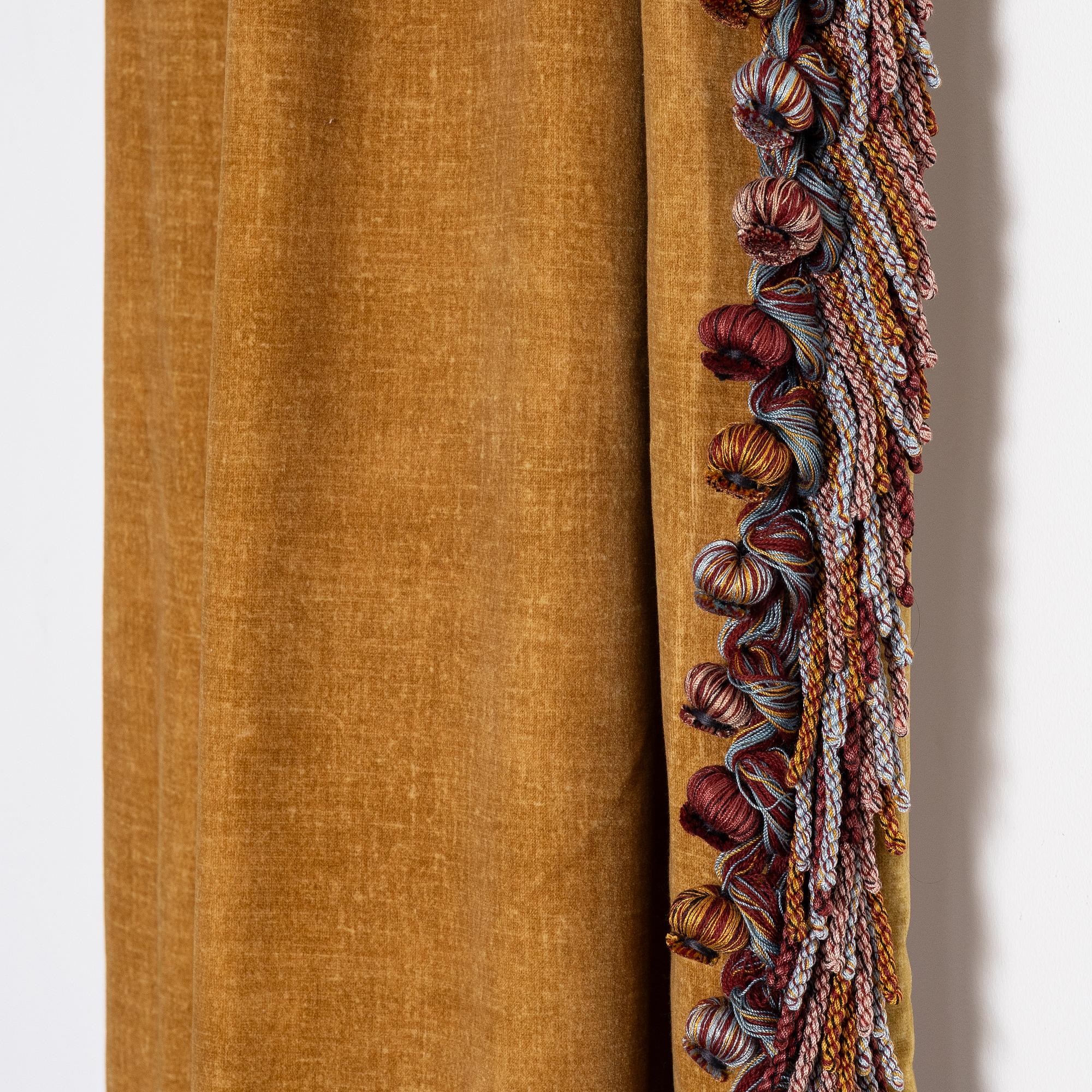 A pair of yellow velvet curtains from Brochier Como.