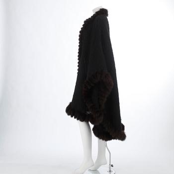 YVES SAINT LAURENT, a black wool and brown fur trimmed cape.