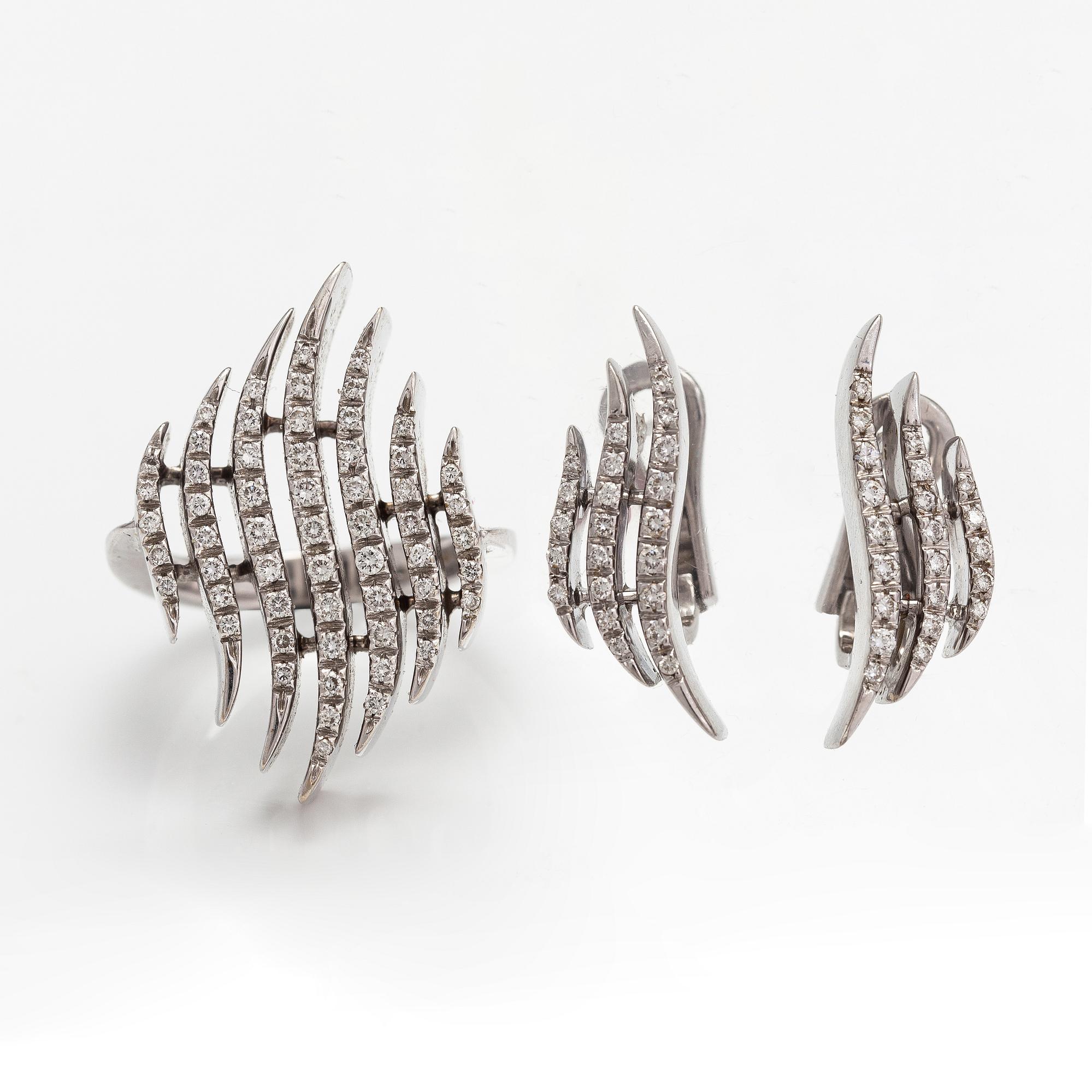 A pair of 18K white gold earrings and a ring with diamonds ca. 0.90 ct in total. Moscow.