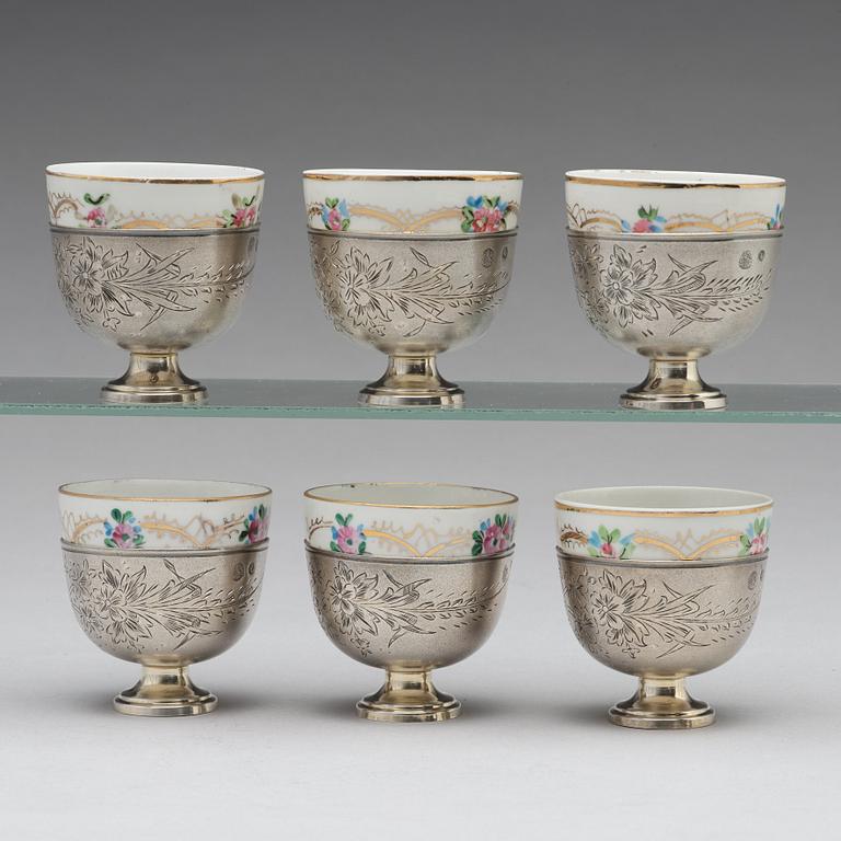 A set of six Ottoman parcel-gilt silver Xarfs with Russian Kuznetzov porcelain cups, c. 1910.