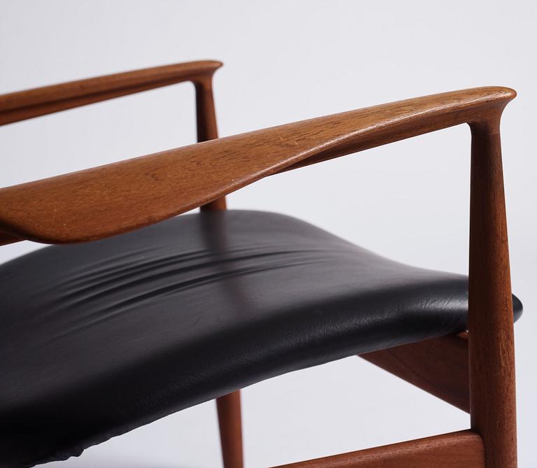 Finn Juhl, a teak and black leather 'model 136' easy chair, France & Daverkosen, Denmark 1950-60s.