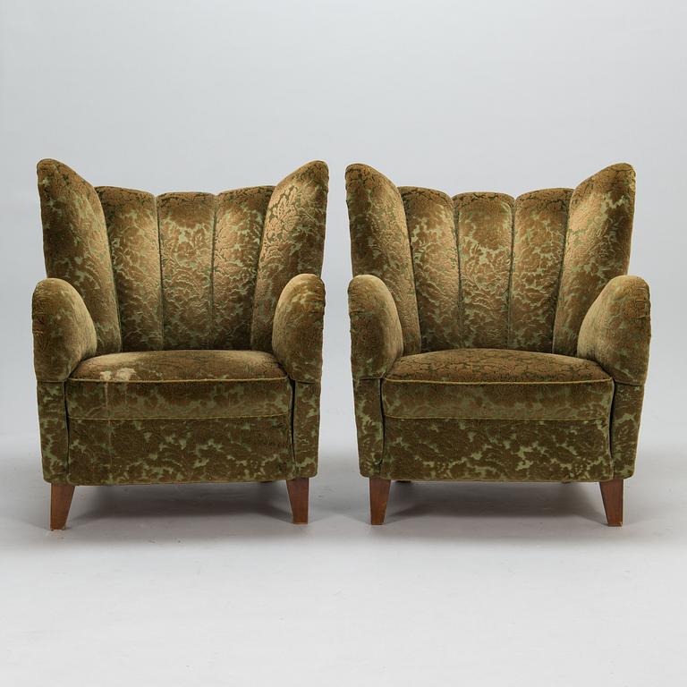 A pair of mid-20th-century armchairs.