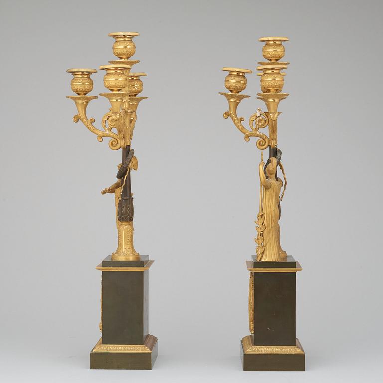A pair of French Empire early 19th century gilt and patinated bronze four-light candelabra.