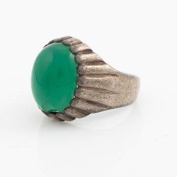 Silver ring with a green cabochon-cut stone.