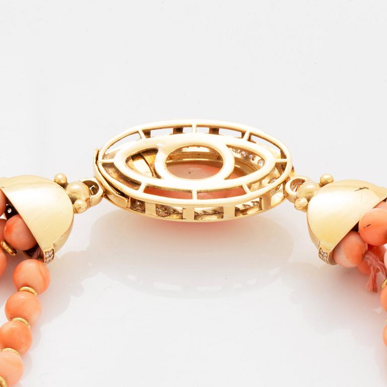 A four strand coral necklace with an 18K gold clasp set with coral and round brilliant-cut diamonds.