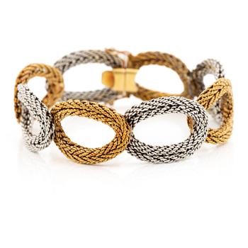 540A. A bracelet 14K two-tone gold in the form of braided oval links, circa 1950-70's.