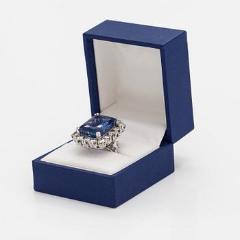 A platinum ring with a ca. 18.00 ct sapphire and ca. 3.00 cts of diamonds. With certificates.