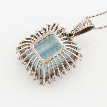 An 18K white gold Engelbert pendant set with a aquamarine and round brilliant-cut diamonds.