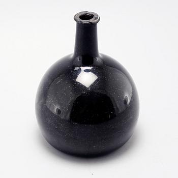 An 18th century glass bottle.