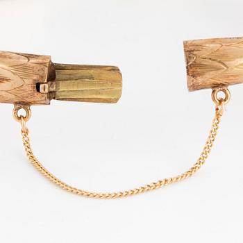 An 18K gold snake bangle with rose-cut diamonds.