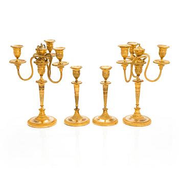 A pair of early 19th century French candelabrums and candlesticks.