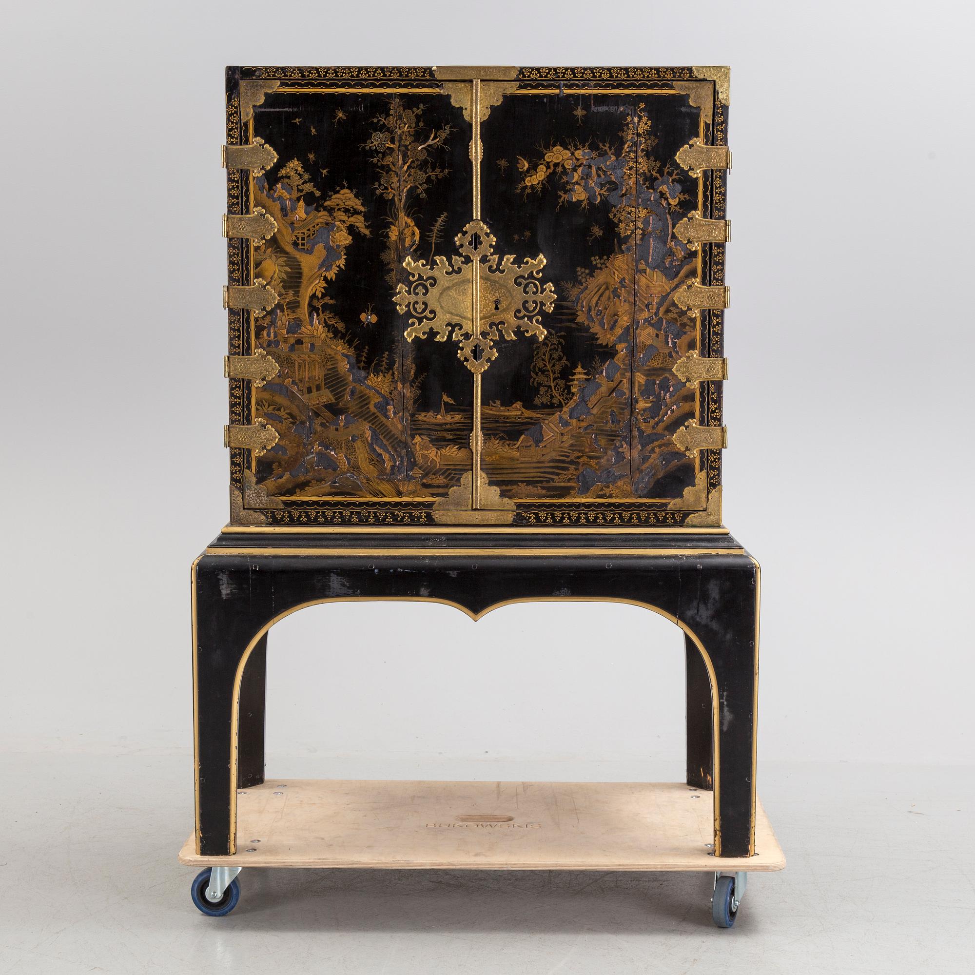 AN early 18TH CENTURY PROBABLY ENGLISH Japanned laquer cabinet on stand.