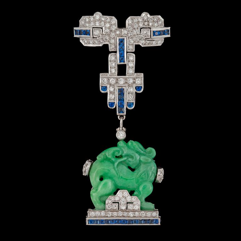 A carved untreated jadeite, sapphire and diamond brooch.
