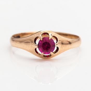 A 14K gold ring with a synthetic ruby.