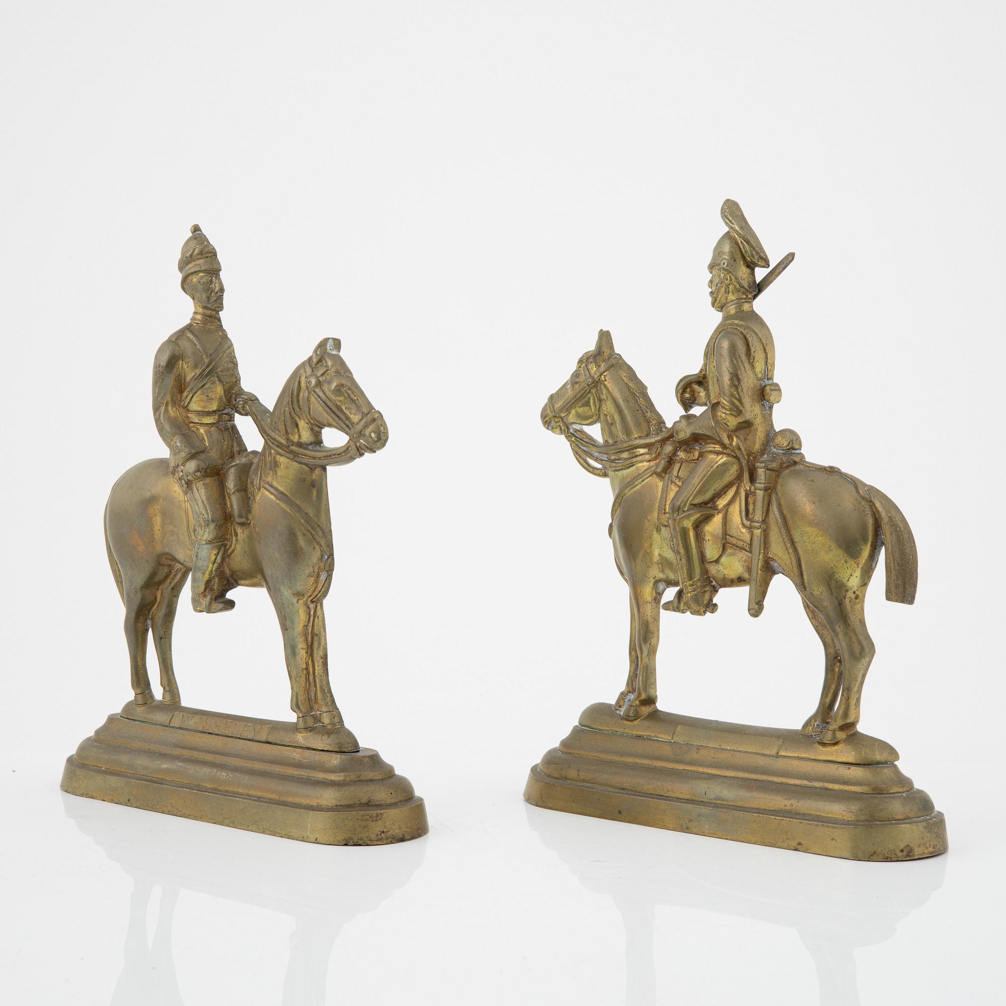 A pair of brass book stands,